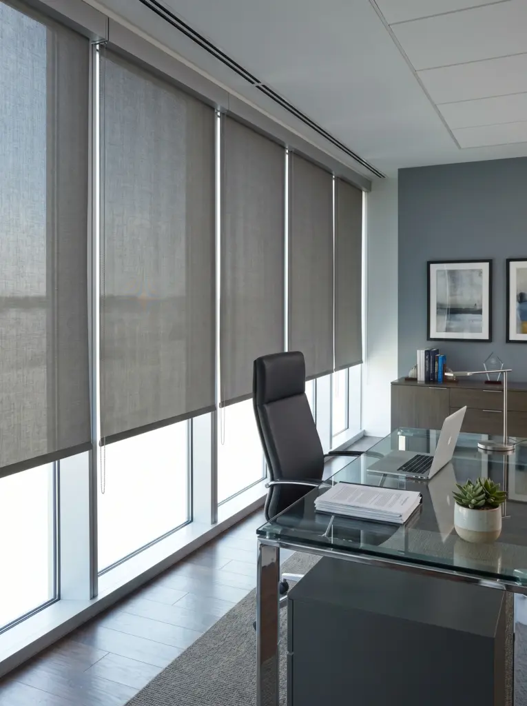 Professional roller blinds installed in a bright executive office suite