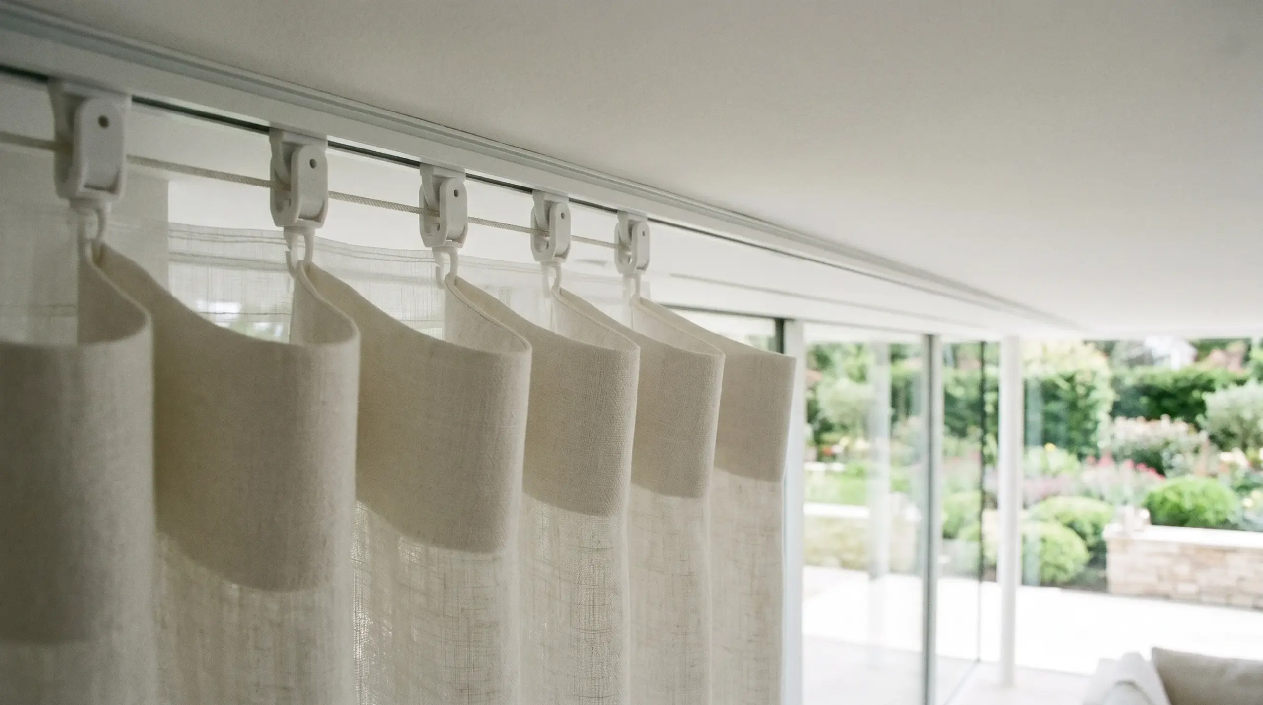 Wave curtain ceiling track detail showing S-fold glider system, custom curtains Dubai villa installation